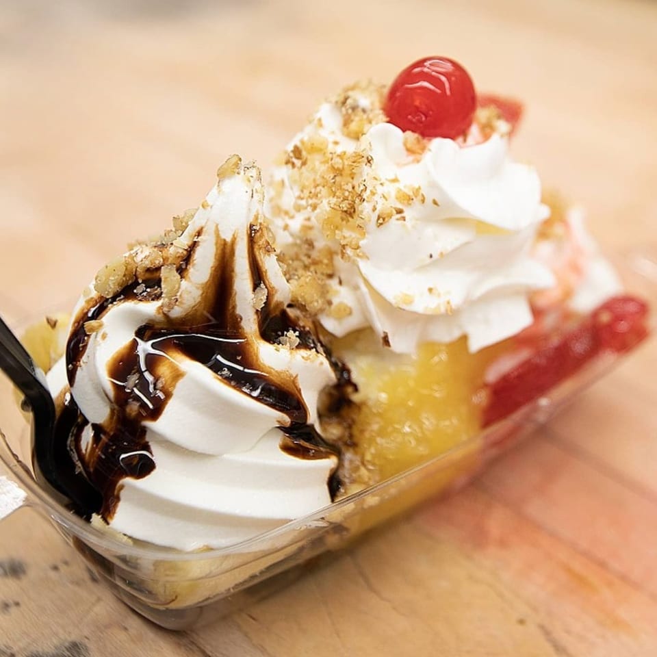 Kirt's Drive-In banana split with soft serve, chocolate syrup, nuts, pineapple, and a cherry.